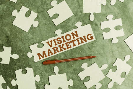Text caption presenting Vision Marketing. Business idea outlining how they plan to change and improve in the future Building An Unfinished White Jigsaw Pattern Puzzle With Missing Last Pieceの写真素材
