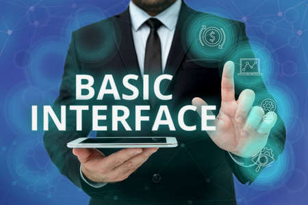 Inspiration showing sign Basic Interface. Business overview boundary across which two independent systems meet and act Man In Office Uniform Standing Pressing Virtual Button Holding Tablet.の写真素材