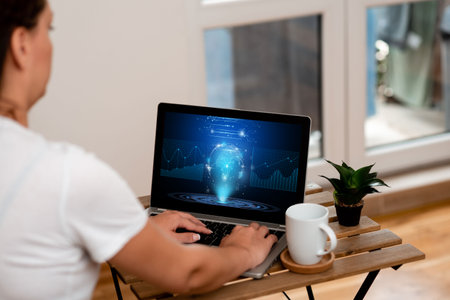 Woman Doing Her Work On A Laptop Next To Beautiful Plant And Coffee Mug Working From Home. Girl Making Projects Next To Cup And Flower Finishing Remote Job Projects.の写真素材