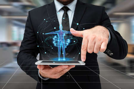 Man In Uniform Standing Holding Tablet And Virtually Typing With Pen. Business Man Carrying Pad Typing And Displaying New Futuristic Technologies.の写真素材