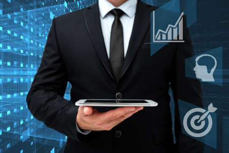Man In Office Uniform Standing Holding Tablet Displaying New Modern Technology. Gentleman In...