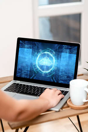 Hand Resting On Laptop Top Of Table Beside Coffee Mug Actively Accomplishing Work From Home. Arm Making New Tasks Next To Cup Finishing Remote Job Projects.の写真素材