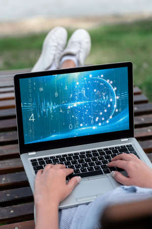 Laptop Resting On Lap Of Woman With Cross Leg Outdoors Accomplishing Her Remote Job. Minicomputer Placed Surface Upper Part Legs Outside Doing Computer Works.の写真素材