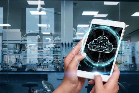 Hands Pressing Screen Of Mobile Phone In Laboratory Showing The Futuristic Technology. Palm Tapping...