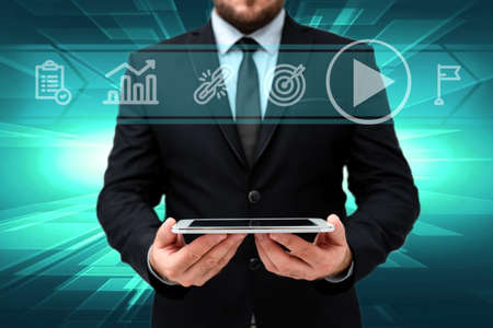 Man In Office Uniform Standing Holding Tablet Displaying New Modern Technology. Gentleman In Business Attire Carrying Tab Pointing New Futuristic Technology.の写真素材