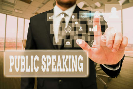 Conceptual caption Public Speaking. Word Written on art of effective oral communication with an audience Man In Office Uniform Standing Pressing Virtual Button Holding Tablet.の写真素材