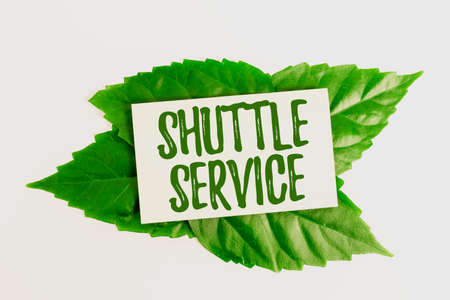 Sign displaying Shuttle Service. Business overview intended to shuttle passengers between two fixed...