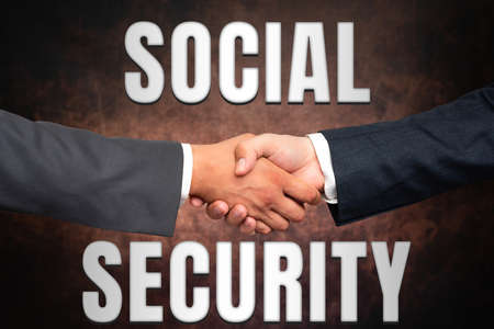 Hand writing sign Social Security. Business overview government system that provide monetary assistance to showing Two Professional Well-Dressed Corporate Businessmen Handshake Indoorsの写真素材