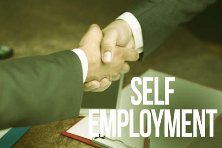 Text showing inspiration Self Employment. Internet Concept working for oneself as a freelance or the owner of a busines Two Professional Well-Dressed Corporate Businessmen Handshake Indoorsの写真素材