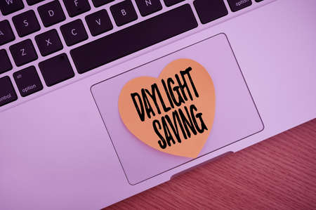 Handwriting text Daylight Saving. Word Written on Storage technologies that can be used to protect data Blank Notepad Laptop With Pen And Headphones Beside Cup Of Warm Coffee.の写真素材