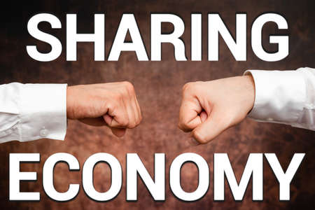 Writing displaying text Sharing Economy. Business showcase economic model based on providing access to goods Two Professional Well-Dressed Corporate Businessmen Handshake Indoorsの写真素材