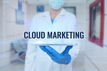 Text showing inspiration Cloud Marketing. Business concept The process of an organisation to market their services Man In Uniform Standing Holding Tablet Showing Medical Futuristic Tech.の写真素材