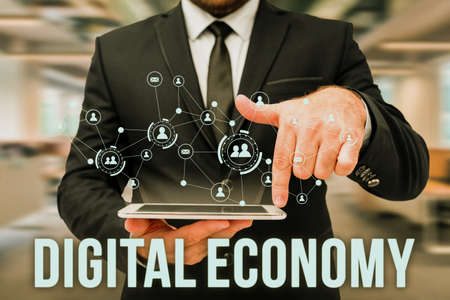 Text showing inspiration Digital Economy. Business showcase worldwide network of economic activities and technologies Man In Uniform Standing Holding Tablet Typing Futuristic Technologies.の写真素材