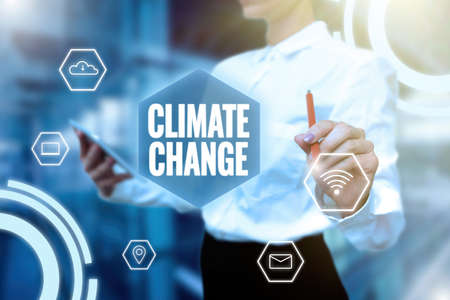 Handwriting text Climate Change. Concept meaning Increase in global average temperature Weather transformation Lady In Uniform Holding Tablet In Hand Virtually Typing Futuristic Tech.の写真素材