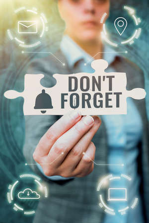 Handwriting text Don T Forget. Business idea used to remind someone about important fact or detail Business Woman Holding Jigsaw Puzzle Piece Unlocking New Futuristic Tech.の写真素材