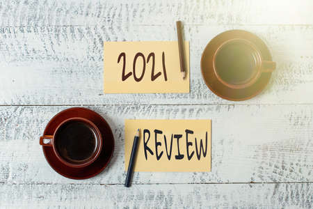 Sign displaying 2021 Review. Internet Concept remembering past year events main actions or good shows Display of Different Color Sticker Notes Arranged On flatlay Lay Backgroundの写真素材