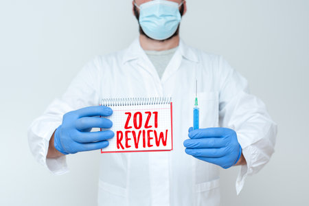 Inspiration showing sign 2021 Review. Word Written on remembering past year events main actions or good shows Researcher Displaying Virus Prevention Method, New Infection Cure Ideasの写真素材