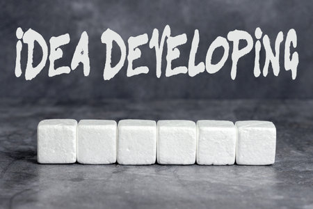 Writing displaying text Idea Developing. Business showcase innovating the concept and bringing the idea to reality Stack of Sample Cube Rectangular Boxes On Surface Polished With Multi-Colourの写真素材
