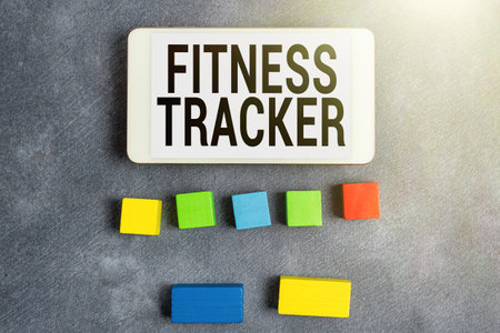 Hand writing sign Fitness Tracker. Word for device that records a persons daily physical activity Stack of Sample Cube Rectangular Boxes On Surface Polished With Multi-Colourの写真素材