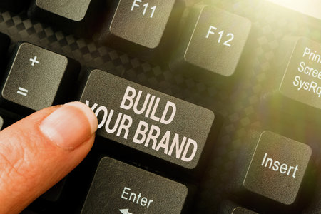 Hand writing sign Build Your Brand. Internet Concept creates or improves customers knowledge and opinions of product Typing New Blog Contents, Writing Movie Scripts, Creating Computer Codesの写真素材