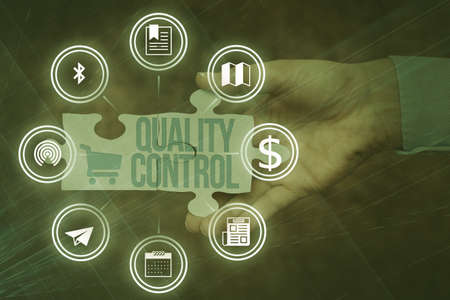 Conceptual display Quality Control. Word Written on insure that product or service sold due to standards Hand Holding Jigsaw Puzzle Piece Unlocking New Futuristic Technologies.の写真素材