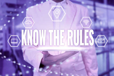 Conceptual caption Know The Rules. Word for set explicit or regulation principles governing conduct Lady Uniform Standing Tablet Hand Presenting Virtual Modern Technologyの写真素材