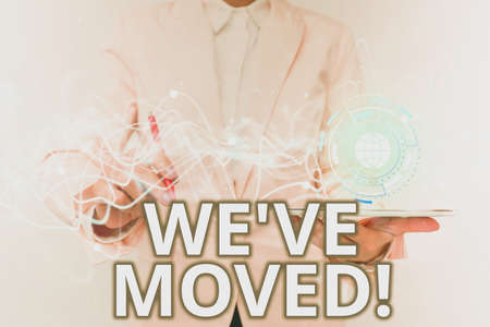 Text sign showing We Ve Moved. Business approach To go from one residence or location to another Relocate Lady In Uniform Using Futuristic Mobile Holographic Display Screen.の写真素材