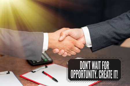 Conceptual caption Don T Wait For Opportunity Create It. Business approach work hard on yourself and begin from this moment Two Professional Well-Dressed Corporate Businessmen Handshake Indoorsの写真素材