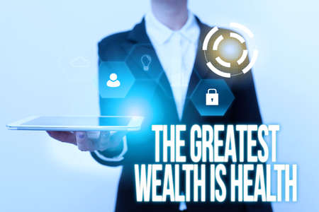 Inspiration showing sign The Greatest Wealth Is Health. Internet Concept Many sacrifice their money just to be healthy Woman In Uniform Displaying Mobile Device Futuristic Virtual Tech.の写真素材