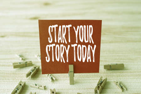 Hand writing sign Start Your Story Today. Business showcase work hard on yourself and begin from this moment Piece Of Blank Square Note Surrounded By Laundry Clips Showing New Idea.の写真素材