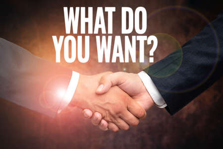 Hand writing sign What Do You Want Question. Business approach say or write in order to ask person about something Two Professional Well-Dressed Corporate Businessmen Handshake Indoorsの写真素材