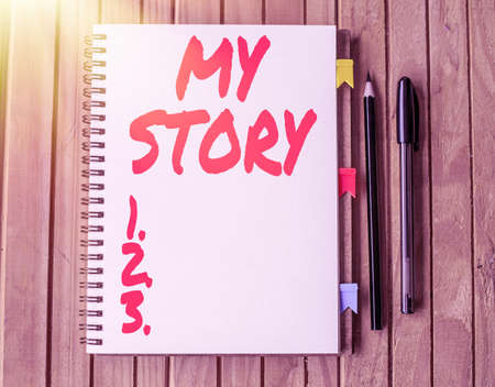 Inspiration showing sign My Story. Business approach your past life events actions or choices you made Blank Open Spiral Notebook With Diffrent Pens Placed On Table.の写真素材
