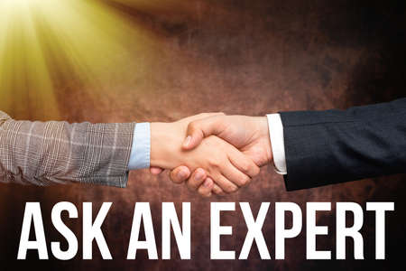 Text caption presenting Ask An Expert. Conceptual photo confirmation that have read understand and agree with guidelines Two Professional Well-Dressed Corporate Businessmen Handshake Indoorsの写真素材
