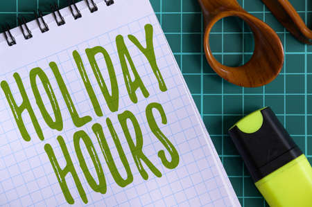 Inspiration showing sign Holiday Hours. Concept meaning Overtime work on for employees under flexible work schedules Multiple Assorted Collection Office Stationery Photo Placed Over Tableの写真素材