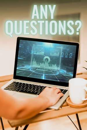 Text showing inspiration Any Questions Question. Word for you say write order to ask person about something Hand Resting On Laptop Top Of Table Beside Cup Working From Home.の写真素材