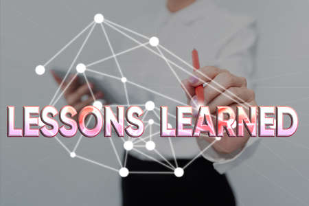 Writing displaying text Lessons Learned. Business concept experiences distilled project that should actively taken Lady In Uniform Standing Holding Tablet Typing Futuristic Technologies.の写真素材