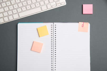 Keyboard Over A Table Beside A Notebook And Pens With Sticky Notes. Computer Keypad On Top Of A Desk...