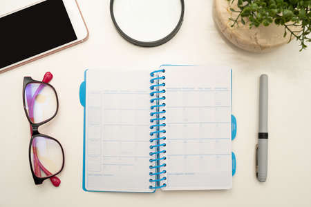 Office Supplies Over Desk With Keyboard And Glasses And Coffee Cup For Working Remotely, Assorted School Utilities For Studying With Hot Drink And Eyeglasses.の写真素材