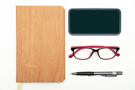 Office Supplies Over Desk With Keyboard And Glasses And Coffee Cup For Working Remotely, Assorted...