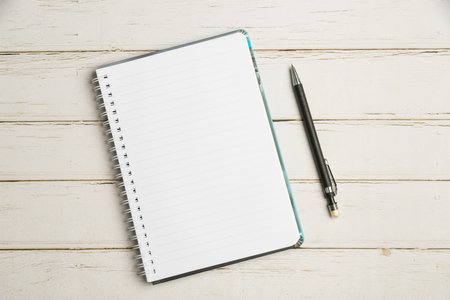 Keyboard Over A Table Beside A Notebook And Pens With Sticky Notes. Computer Keypad On Top Of A Desk With A Office Supplies And Desk Photo..の写真素材