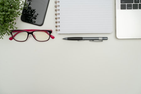 Office Supplies Over Desk With Keyboard And Glasses And Coffee Cup For Working Remotely, Assorted School Utilities For Studying With Hot Drink And Eyeglasses.の写真素材