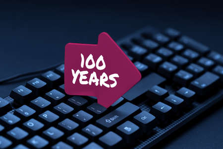 Text sign showing 100 Years. Business idea Remembering special day for being 100 years in existence Typing Old Notes To A Computer, Abstract Creating Emotional Novelの写真素材