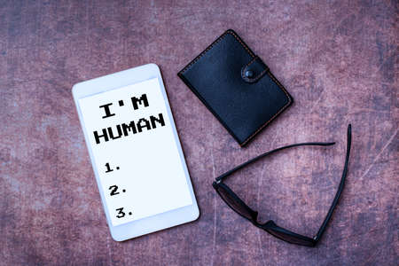 Inspiration showing sign I M Human. Business overview used for saying someone has been weak in the ways and got mistake Wooden Desktable With Smartphone Leather Wallet And Eyeglassesの写真素材