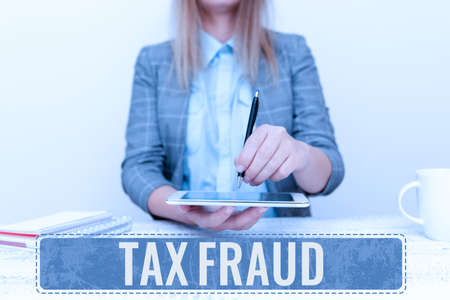 Hand writing sign Tax Fraud. Business approach entails cheating on a tax return in an attempt to avoid paying Displaying New Smartphone Technology, Discussing Device Improvementsの写真素材