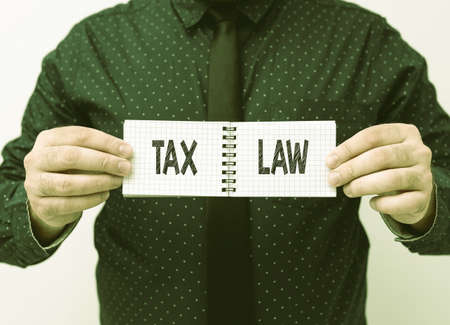 Hand writing sign Tax Law. Internet Concept governmental assessment upon property value or transactions Presenting New Plans And Ideas Demonstrating Planning Processの写真素材