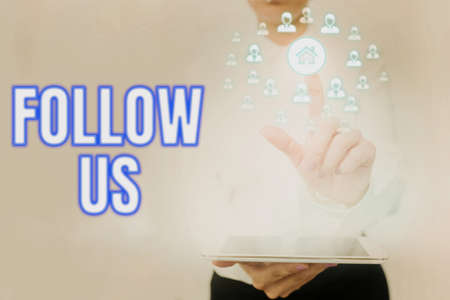 Handwriting text Follow Us. Business concept To invite a person or group to join his company and take rules Lady Holding Tablet Pressing On Virtual Button Showing Futuristic Tech.の写真素材