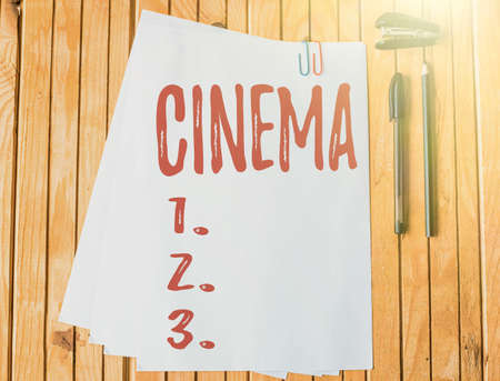 Sign displaying Cinema. Internet Concept theater where movies are shown for public entertainment Movie theater Office Stationery Paper Clipped Together Laying Flat On Table.の写真素材