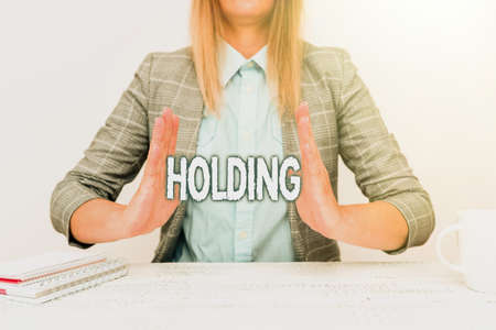Text sign showing Holding. Conceptual photo stocks property and other financial assets in someone s is possession Explaining New Business Plans, Orientation And Company Introductionの写真素材