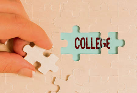 Sign displaying College. Business approach educational institution or establishment providing higher education Building An Unfinished White Jigsaw Pattern Puzzle With Missing Last Pieceの写真素材