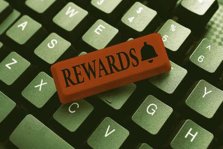 Hand writing sign Rewards. Business showcase Given in recognition of service effort achievement...